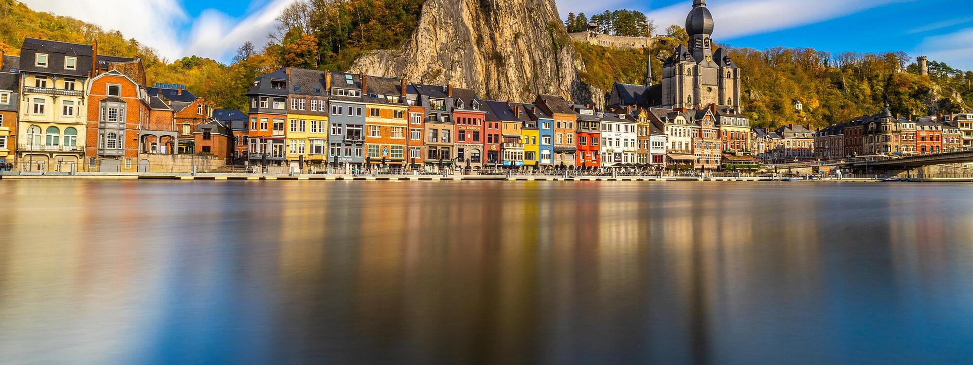De kathedraal en de citadel torenen boven de kade van Dinant aan de Meuse